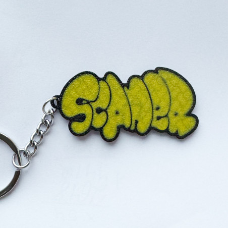 Llavero amarillo con diseño del escritor de graffiti Scaner